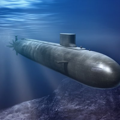 A grey aerodynamic submarine submerged in blue water